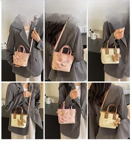 Detailed views of a trendy mini bucket bag with butterfly prints and dog charm