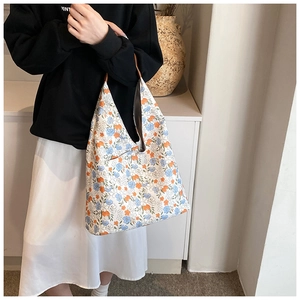 Detailed view of floral pattern and canvas texture on a stylish hobo shoulder tote bag
