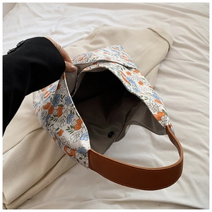 Detailed interior view of floral tote bag featuring metal snap button and dark lining