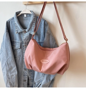 Detailed view of pink pleated hobo bag with iFashion plate and adjustable strap