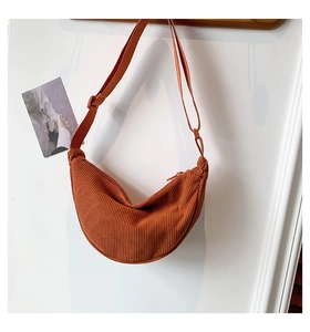 Detailed view of caramel corduroy crescent bag with textured stripes and adjustable strap