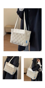 Close-up of quilted pattern and embossed logo on large capacity tote bag for work