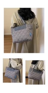 Detail of grey quilted tote bag showing rhombus stitching and embossed brand logo