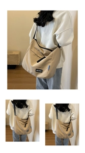 Detail of khaki large capacity nylon tote with zipper closure and logo label