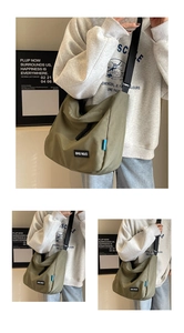Detail view of large olive canvas tote bag showing the adjustable wide nylon strap