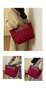 Detail of red quilted tote bag featuring a leather brand patch and premium nylon texture