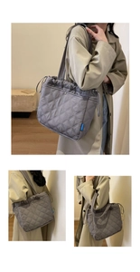 Détail d'un sac cabas gris matelassé avec fermeture à cordon et motif en losanges