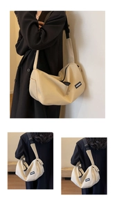 Seitenansicht der beigen Canvas-Umhängetasche mit verstellbarem Gurt und Fashion-Label
