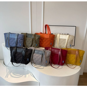 Quilted tote bags in 8 vibrant colors displayed on a clean tiered background