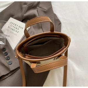 Top view of two-tone bucket bag interior showing zip compartment and brown lining