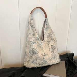 White lace tote bag with blue butterfly embroidery and brown leather handles for women