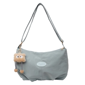 Fashionable light blue pleated tote bag with adjustable strap and monster charm