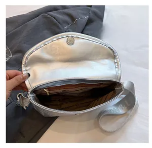 Vista macro dell'interno della borsa a tracolla intrecciata argento con tasca con zip