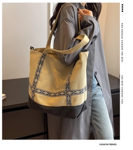 Detail view of large canvas tote bag with ethnic floral ribbon and patchwork design
