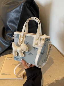 Gray-blue summer bucket bag with cream white handles and a cute puppy leather charm