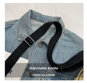 Detail of adjustable black nylon shoulder strap with polished silver metal buckle on bag
