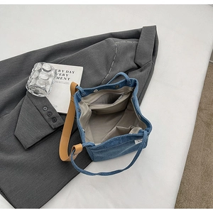 Internal view of denim tote bag with magnetic clasp and organized storage pockets