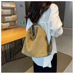 Detail of khaki canvas hobo bag with wide adjustable strap for commuting and daily use