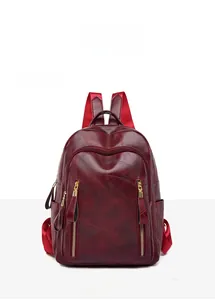 Front view of a vintage wine red PU leather backpack with decorative double zippers