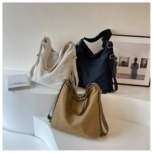 Detailed shot showing high-capacity canvas tote bags in white black and khaki colors
