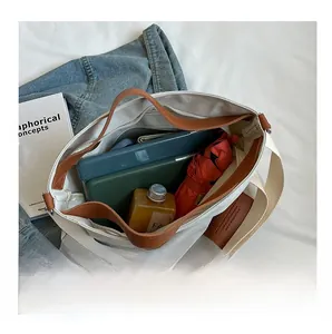 Top-down view of spacious interior of canvas tote bag storing iPad and daily essentials