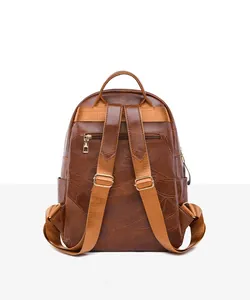 Detail view of the brown PU leather backpack rear with anti-theft zipper and adjustable straps