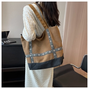 Detail view of ethnic embroidery ribbons on a brown canvas tote bag for women