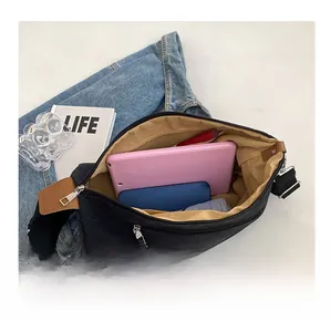 Detail view of the black canvas bag interior featuring spacious storage and a zipper pocket