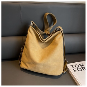 Detail of khaki large canvas tote bag showing wide strap and silver metal buckle