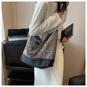 Detail of canvas tote bag with ethnic floral embroidery and adjustable crossbody strap