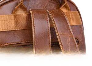 Macro detail of high-quality stitching and litchi texture on brown leather backpack