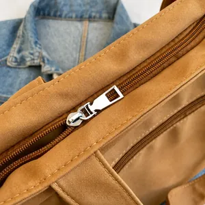Macro shot of smooth silver metal zipper and khaki oxford fabric texture on the tote bag