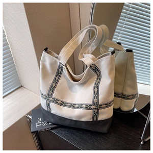 Detailed view of canvas tote bag with vintage geometric embroidery and sturdy handles