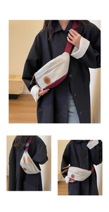 Detail of cream and burgundy canvas crossbody chest bag with round leather logo patch
