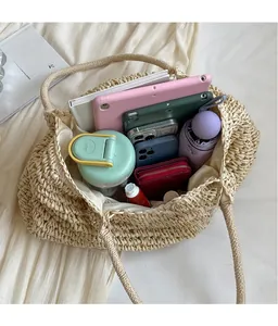 Top view of large straw tote bag interior showing spacious capacity with daily essentials