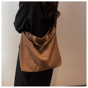 Détail du grand sac cabas en toile marron montrant le drapé et la vue latérale spacieuse