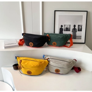 Detailed display of colorful canvas crossbody bags with adjustable straps and logo detail