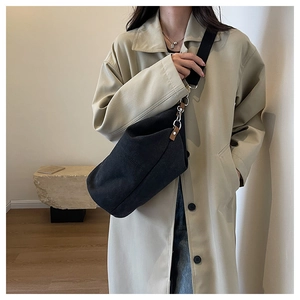 Fashionable black canvas shoulder bag with brown leather detail and wide fabric strap