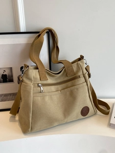 Sac cabas minimaliste en toile kaki avec bandoulière réglable et grande capacité de rangement