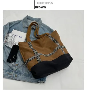 Detail view of large canvas tote bag with ethnic embroidery and detachable strap
