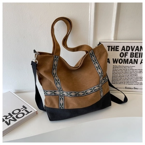 Detailed view of the brown canvas tote bag with ethnic snowflake pattern and black strap