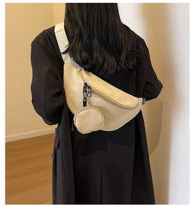 Back view of cream canvas crossbody chest bag with round coin purse and wide strap