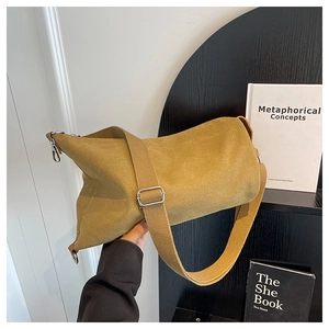 Detail of ginger yellow minimalist canvas crossbody bag with wide strap and silver buckle