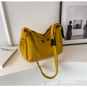 Détail du sac fourre-tout en toile jaune moutarde avec poche latérale et zip noir frontal