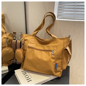Detailed view of ginger yellow tote bag with large zipper pocket and mini coin purse