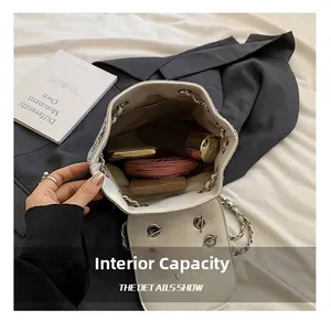 Detailed top view of a white leather bucket bag interior showing ample storage space