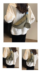 Detail of army green canvas crossbody bag with adjustable strap and small coin pouch