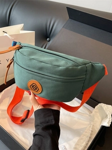 Sporty dark green canvas crossbody chest bag with vibrant orange strap and leather logo