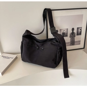 Détail du sac fourre-tout minimaliste en toile noire avec double zip et cordon de serrage