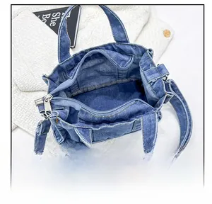 Internal view of blue denim tote bag showing spacious lining and zipper closure
